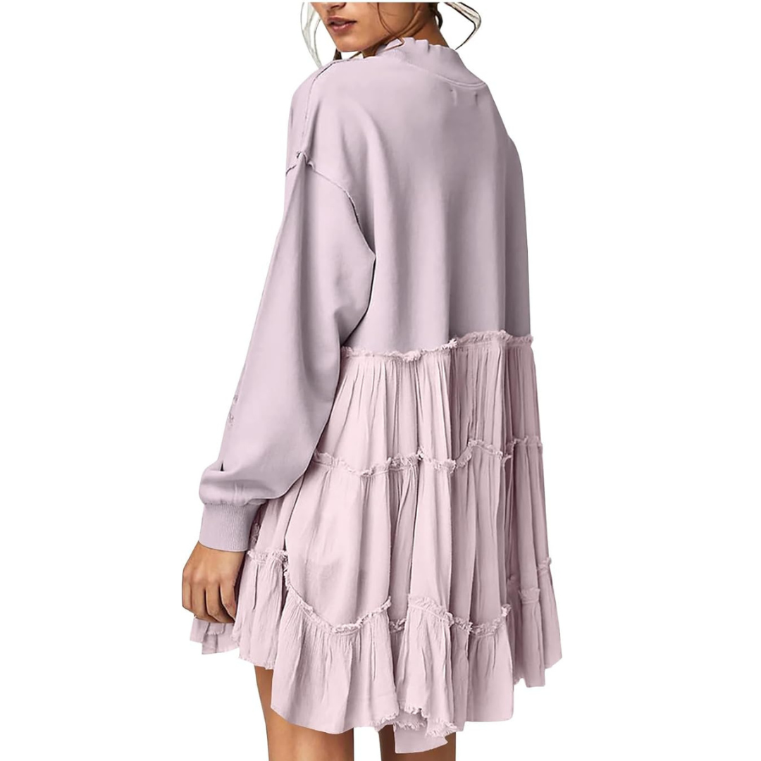 A woman wearing a lilac ruffled hem sweatshirt.