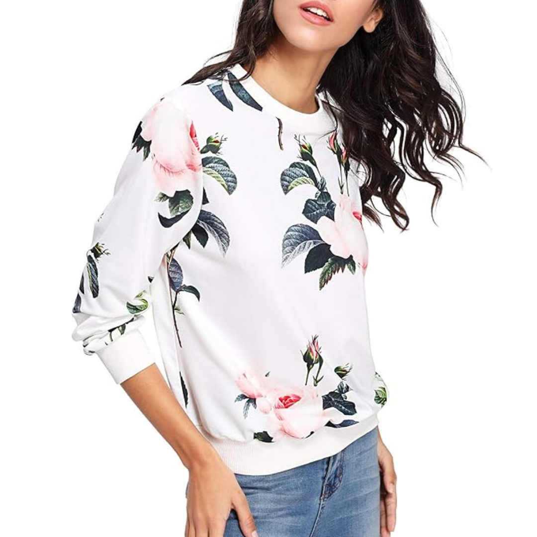 A woman wearing a white floral print sweatshirt.